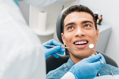 cheerful african american man with during examination in dental clinic.